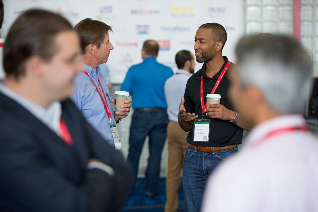 Image of attendees enjoying a cup of coffee during coffee break